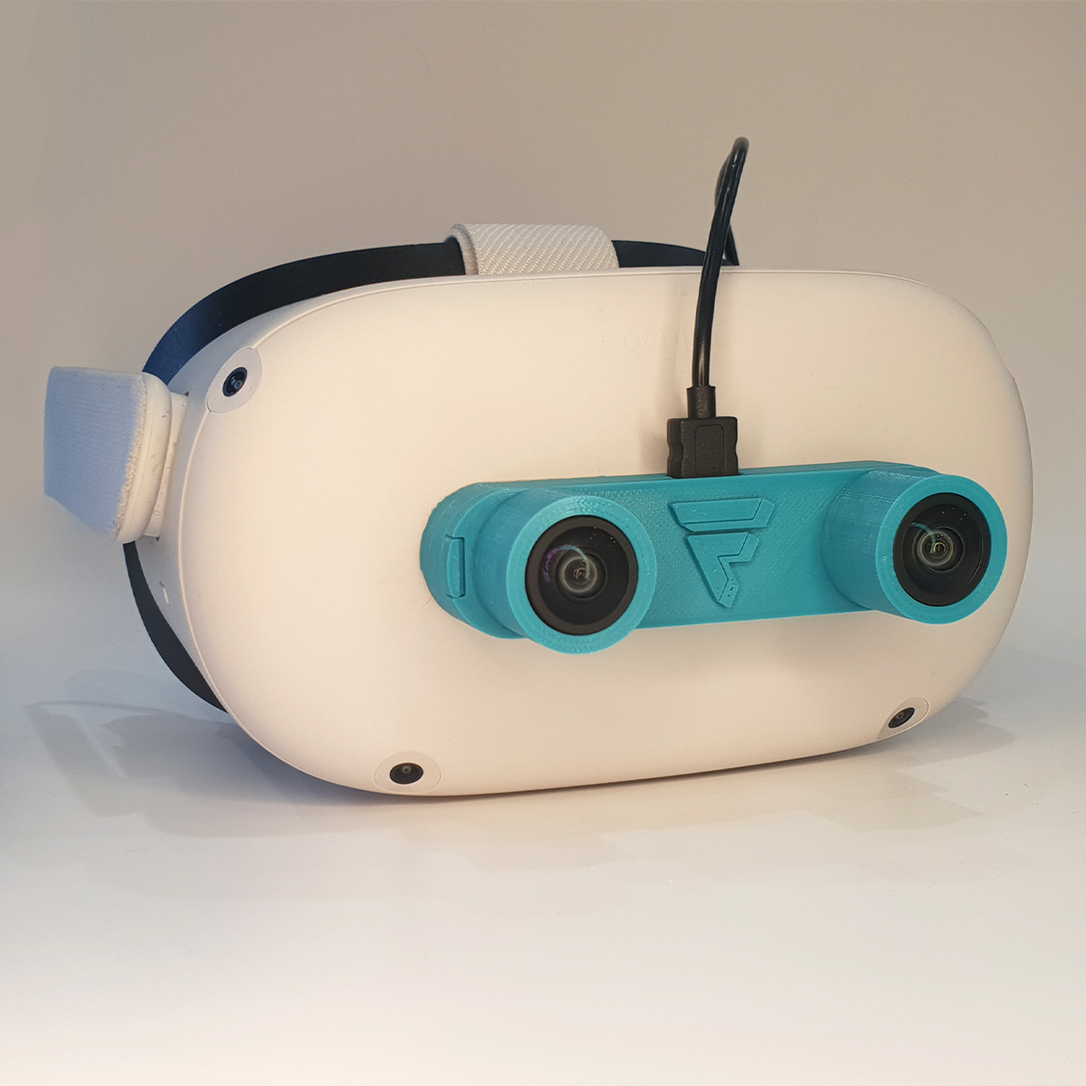 The Foxus camera, in bright blue, mounted on the front of a Meta Quest 2 headset.